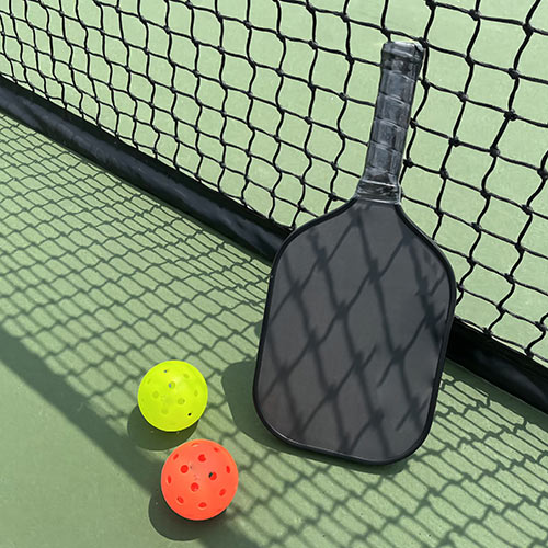 What are some popular brands that manufacture Pickleball paddles?